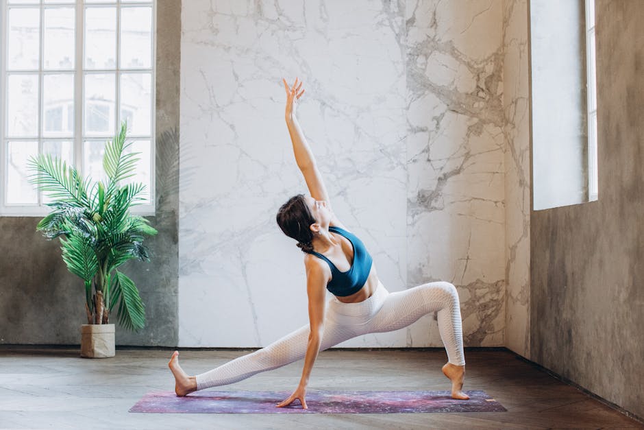 Athlete performing a calm yoga stretch in a bright, modern studio
